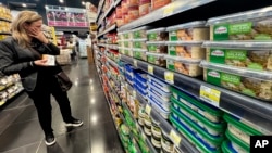 A woman shops at a supermarket where goods are priced in dollars, in Beirut, Lebanon, March 1, 2023. 