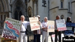 Protesters hold plaques outside the Royal Courts of Justice in London, Britain July 5, 2017.