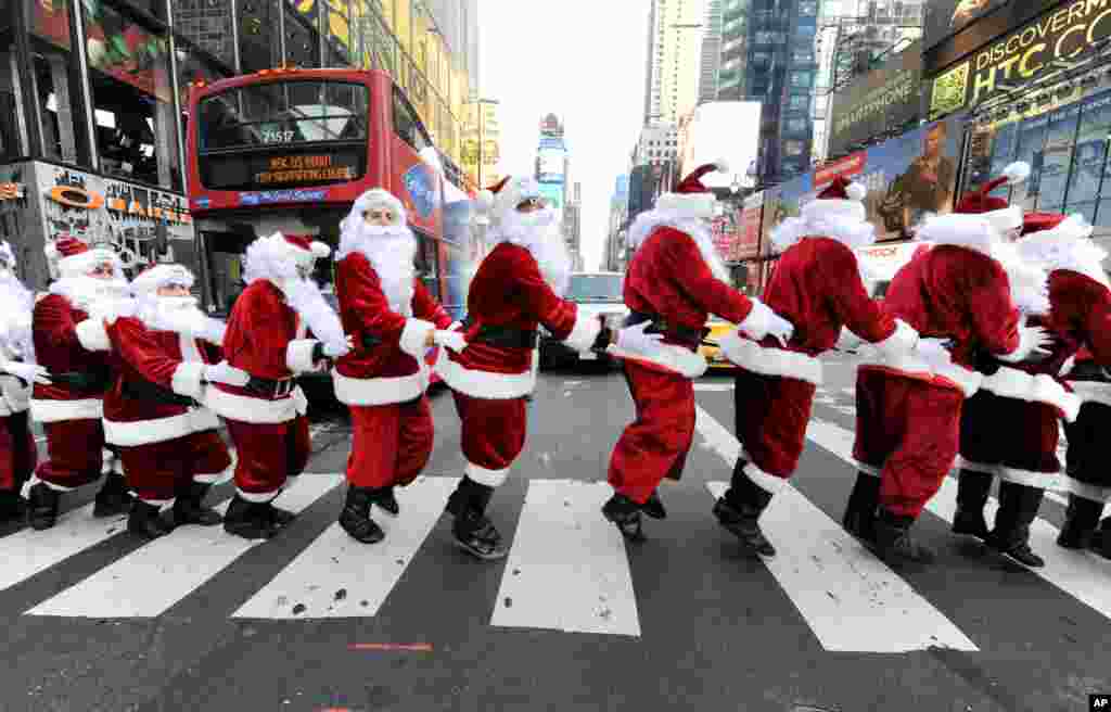 Santa Clauses bunny hop through Times Square as they deliver holiday PEEPS and spread cheer in New York, Dec. 4, 2013.