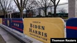 Signs for the inauguration of President-elect Joe Biden stand near the White House in Washington