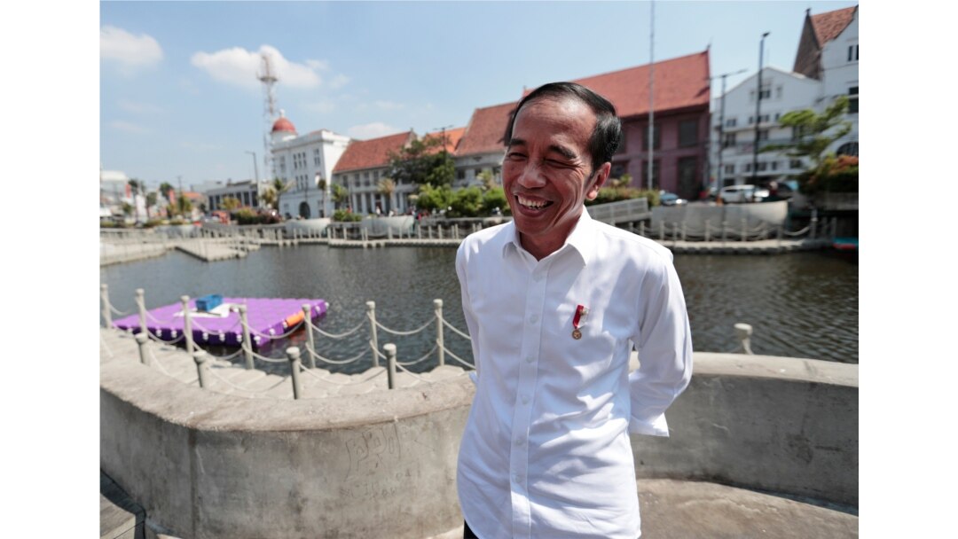 Indonesian President Joko Widodo smiles as he talks to The Associated Press during his visit at the newly revitalized 18th century Kali Besar Canal at the Old Town in Jakarta, Indonesia, July 26, 2019.