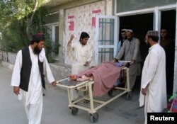 FILE - Relatives move a boy who was injured during border clashes between Pakistan and Afghanistan forces on the border area, at a hospital in Chaman, Pakistan, May 5, 2017.