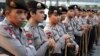 FILE - Indonesian police stand guard ahead of a planned protest at a major intersection in Jakarta, July 22, 2014. 