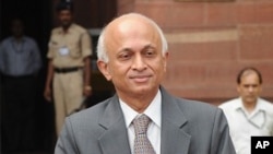India's new Foreign Secretary, Ranjan Mathai, poses for media as he arrives at the External Affairs Ministry in New Delhi on August 1, 2011.