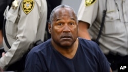FILE - In this May 14, 2013, file photo, O.J. Simpson sits during a break during a hearing in Clark County District Court in Las Vegas. Simpson, the former football star, TV pitchman and now Nevada prison inmate, is seeking his release after more than eight years for an ill-fated bid to retrieve sports memorabilia.