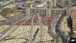 In this image released by the Saudi Press Agency (SPA), hundreds of thousands of Muslim pilgrims make their way to cast stones at a pillar symbolizing the stoning of Satan in a ritual called "Jamarat," the last rite of the annual hajj, on the first day of