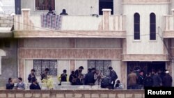 Members of the Free Syrian Army gather at a house in the northern Syrian town of Ras al-Ain, as seen from the Turkish border town of Ceylanpinar, Sanliurfa province, November 26, 2012. 