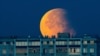 A partial lunar eclipse is seen over the residential building in Moscow, Russia, Sept. 18, 2024.