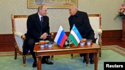 Russian President Vladimir Putin (L) meets with his counterpart from Uzbekistan, Islam Karimov, in Tashkent, Uzbekistan, Dec. 10, 2014.