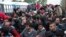 Migrants wait in front of a registration camp for migrants in Opatovac, Croatia, Sept. 22, 2015. 