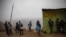 Residents wait in line at a "community pot" in the Nueva Esperanza neighborhood of Lima, Peru, June 17, 2020. For many residents the "community pot" is their only defense against a hunger that's become a constant amid the COVID-19 pandemic.