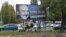 FILE - Activists from the Egyutt (Together) opposition party stand in front of billboards of the government's campaign against George Soros and his support for migration in Budapest, Oct. 5, 2017.