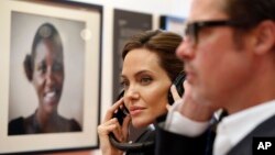 Angelina Jolie and Brad Pitt listen to victims' testimonies at a summit to end sexual violence in conflict, in London, June 12, 2014.