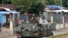 Members of the Armed Forces of Guinea drive through the central neighborhood of Kaloum in Conakry, Sept. 5, 2021 after sustainable gunfire was heard.