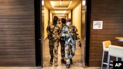 Des soldats de la junte traversent un hôtel lors d'une réunion avec des représentants de haut niveau de la Communauté économique des États de l'Afrique de l'Ouest (CEDEAO), à Conakry, en Guinée, le 17 septembre 2021.