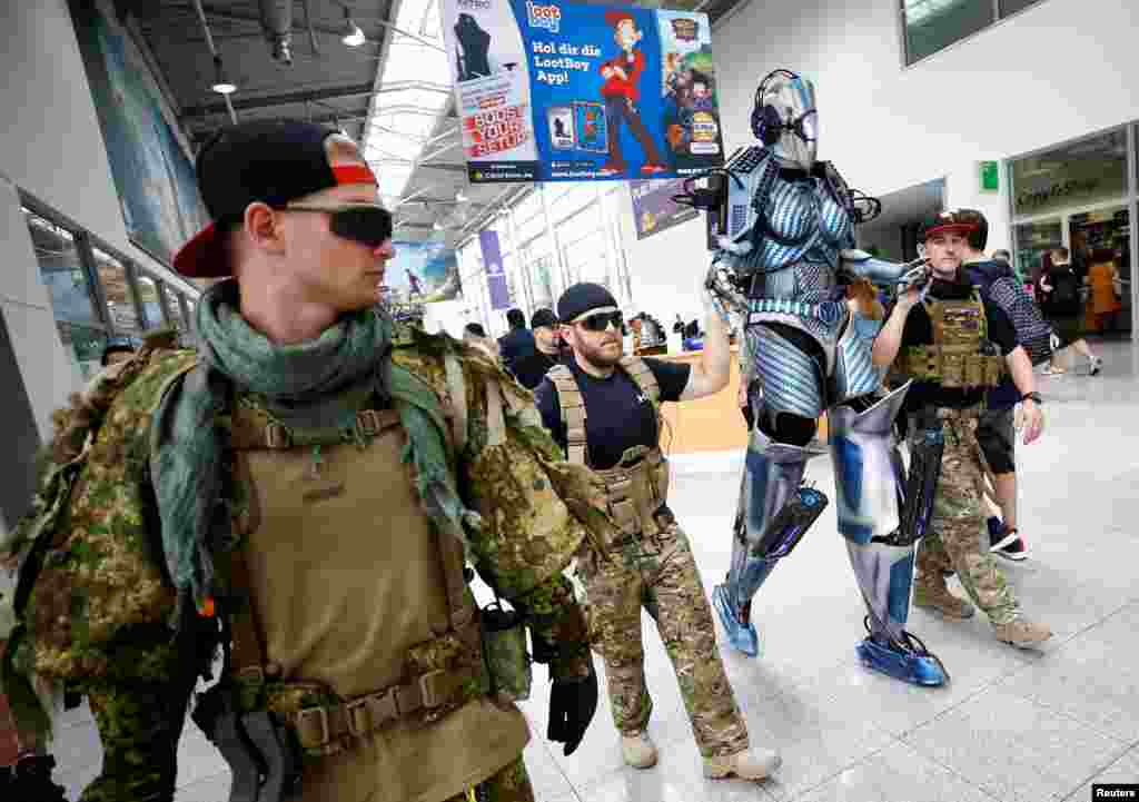 Cosplayers are seen during the media day of the world&#39;s largest computer games fair, Gamescom, in Cologne, Germany.