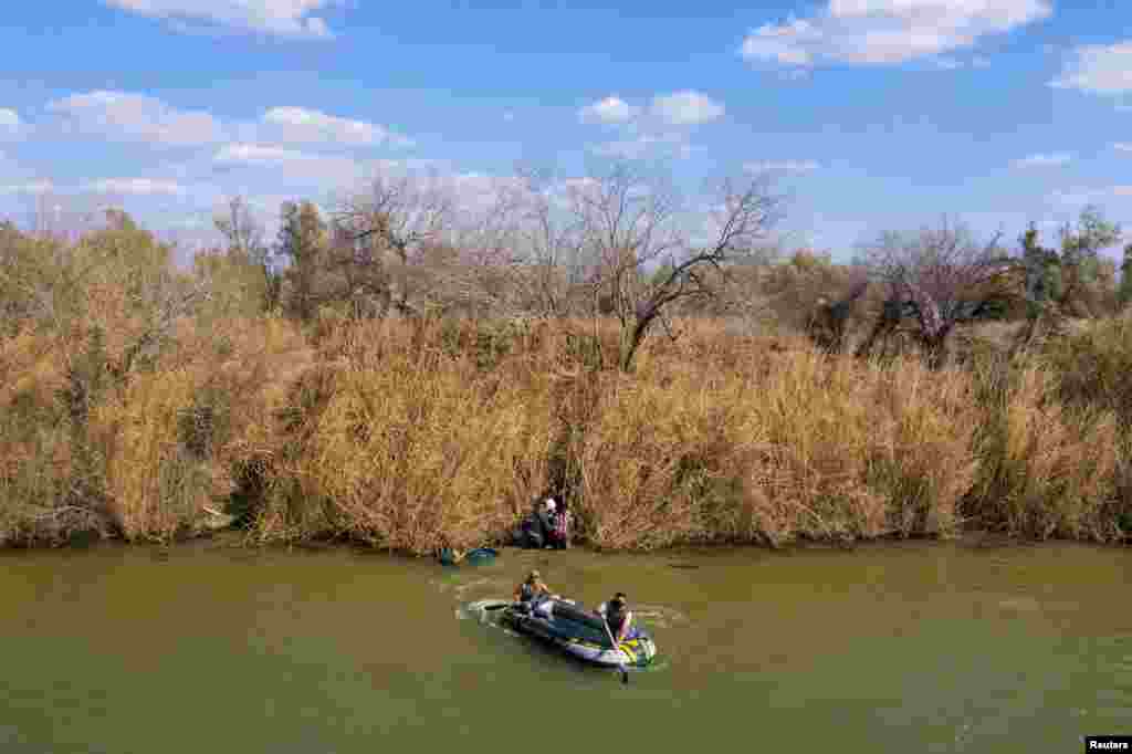 Smugglers return to Mexico after transporting migrant families and children across the Rio Grande River into the United States in Penitas, Texas, March 6, 2021.