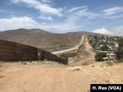 A fence runs along the U.S.-Mexico border.