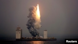 A Long March 11 carrier rocket takes off from a mobile launch platform in the Yellow Sea off Shandong province, China, June 5, 2019.