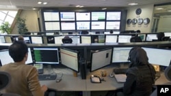 Iranian technicians monitor data flow in the control room of an internet service provider in Tehran, February 15, 2011