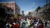 Haitians respond to a nationwide push to block streets and paralyze the country's economy as they press for President Jovenel Moise to give up power, in Port-au-Prince, Haiti, Sept. 30, 2019.