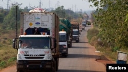 FILE - A convoy of trucks carrying food from the United Nations World Food Programme (WFP) that was stuck at the Cameroon-Central African Republic border for several days due to sectarian insecurity on the road, approaches the north of the capital Bangui.