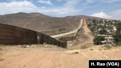 FILE - A fence runs along the U.S.-Mexico border. Authorities say gunfire struck a U.S. Border Patrol agent's marked vehicle just north of the U.S.-Mexico border in San Diego.