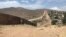 FILE - A fence runs along the U.S.-Mexico border. Authorities say gunfire struck a U.S. Border Patrol agent's marked vehicle just north of the U.S.-Mexico border in San Diego.