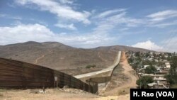 A fence runs along the U.S.-Mexico border.