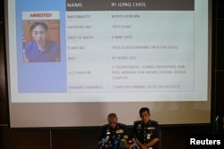 Malaysia's National Police Deputy Inspector-General Noor Rashid Ibrahim (front left) speaks in front of a screen showing detained North Korean Ri Jong Chol during a news conference regarding the apparent assassination of Kim Jong Nam.
