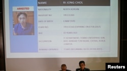 Malaysia's National Police Deputy Inspector-General Noor Rashid Ibrahim (front left) speaks in front of a screen showing detained North Korean Ri Jong Chol during a news conference regarding the apparent assassination of Kim Jong Nam.