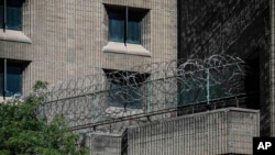 FILE - Razor wire fencing is seen at the Metropolitan Correctional Center in New York, Aug. 10, 2019. Advocates are calling for a reduction of the number of people in custody during the ongoing coronavirus pandemic.