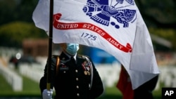 FILE - A cadet attends an annual Memorial Day commemoration at the Los Angeles National Cemetery in Los Angeles, May 25, 2020. 
