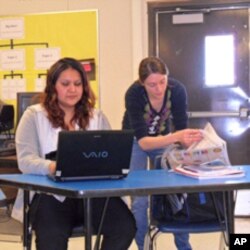 Nicky Oulette reviews the current issue of the Mustang News while Madeline Buckman works on her column.