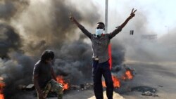 Sudanese protesters burn tires to block a road in 60th Street in the capital Khartoum, to denounce overnight detentions by the army of members of Sudan's government, on Oct. 25, 2021.