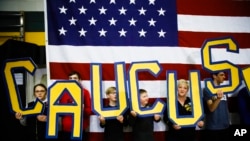 Election 2020 Iowa Mess Sunday, Feb. 2, 2020, file photo, attendees hold letters that read "CAUCUS" during a campaign event for Democratic presidential candidate former South Bend, Ind., Mayor Pete Buttigieg