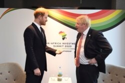Britain's Prince Harry and Prime Minister Boris Johnson, right, at the UK Africa Investment Summit in London, Jan. 20, 2020.