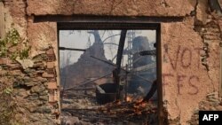 FILE: A house burns during a wildfire in Tizi Ouzou, one of the most populous cities in Algeria's Kabylie region, on 8.10.2021 