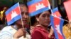 Garment workers welcome Prime Minister Hun Sen outside of Phnom Penh, Cambodia, Wednesday, Aug. 30, 2017. Hun Sen is on a country-wide trip to visit the nation's factory workers to hear their hopes and concerns in person. (AP Photo/Heng Sinith)