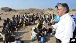 UN refugee agency chief Antonio Guterres (R) speaks to Ethiopian illegal immigrants from the Oromo region waiting for smugglers' boats to cross the Gulf of Aden into Yemen. Each year tens of thousands of Ethiopians and Somalis make the perilous crossing t