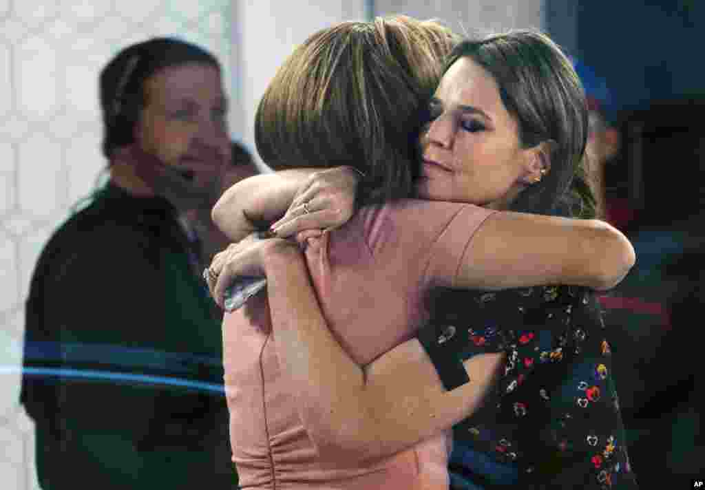 Co-anchors Hoda Kotb, left, and Savannah Guthrie embrace on the set of the &quot;Today&quot; show in New York, after NBC News fired host Matt Lauer. NBC News announced that Lauer was fired for &quot;inappropriate sexual behavior.&quot;