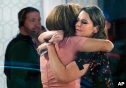 FILE - Co-anchors Hoda Kotb, left, and Savannah Guthrie embrace on the set of the "Today" show, Nov. 29, 2017, in New York, after NBC News fired host Matt Lauer.