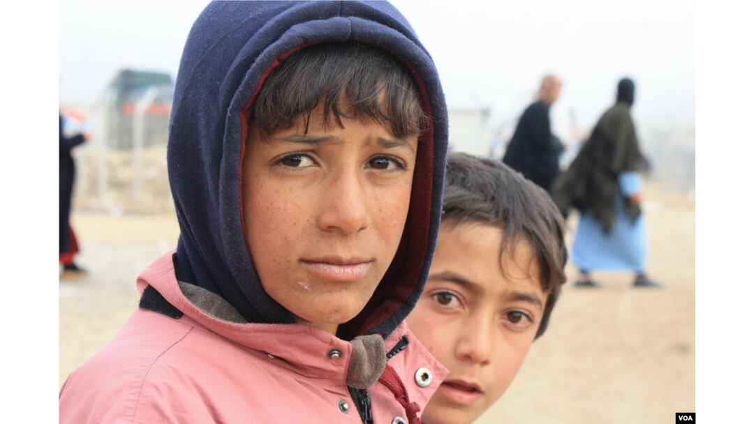 Mothers say even barbers that cut small boys' hair in a way inconsistent with IS rules are subject to severe punishments, at the Khazir camp in Kurdish Iraq, Dec. 13, 2016. (H. Murdock/VOA)