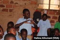 An upper primary male student of Parents Care Infant Academy answers a question on reusable sanitary towels in Makindye, Kampala, Uganda.