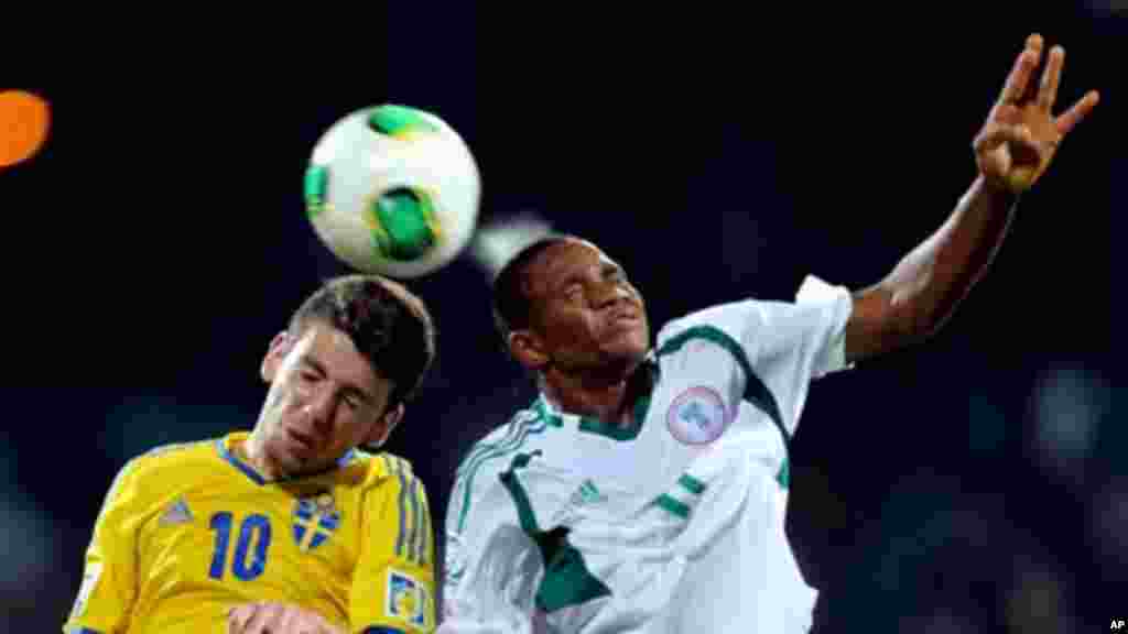 Erdal Rakip of Sweden vies for the ball against Musa Yahaya of Nigeria during a semifinal match of the World Cup U-17 in Dubai.