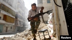 FILE - A Free Syrian Army fighter takes cover during clashes with the Syrian Army.