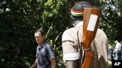 Armed men man the gates of a farm seized from white farmers in Chegutu 120km south west of Harare (File)