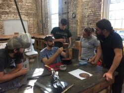 A copper smithing class at the American College of the Building Arts, Charleston, S.C. (J. Taboh/VOA News)