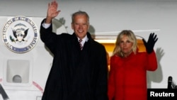 US Vice President Joe Biden (L) and his wife Jill wave upon their arrival at Boryspil International airport outside Kyiv November 20, 2014.