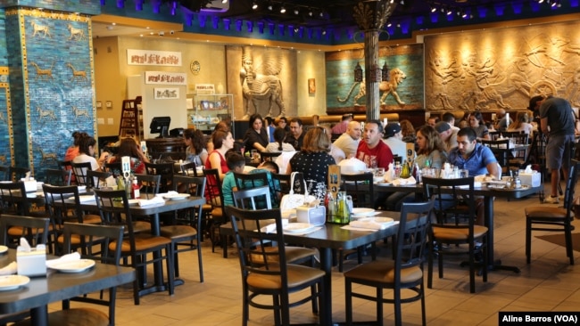 The Ishtar Restaurant, its walls hung with reproductions of Assyrian deities, is a "piece of home" for Iraqi nationals who come for the authentic Iraqi food and glass clinking presentations that proclaim "tea time," in Sterling Heights, Michigan, July 31, 2017.